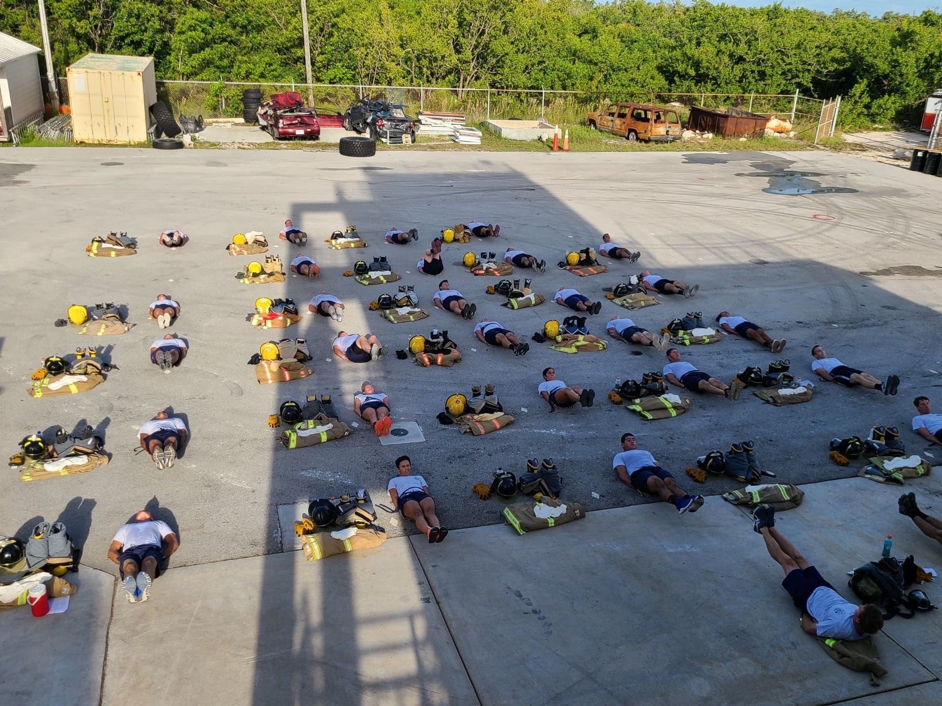 The Hot Shots lay down on the ground and do warm-ups in rows during training.
